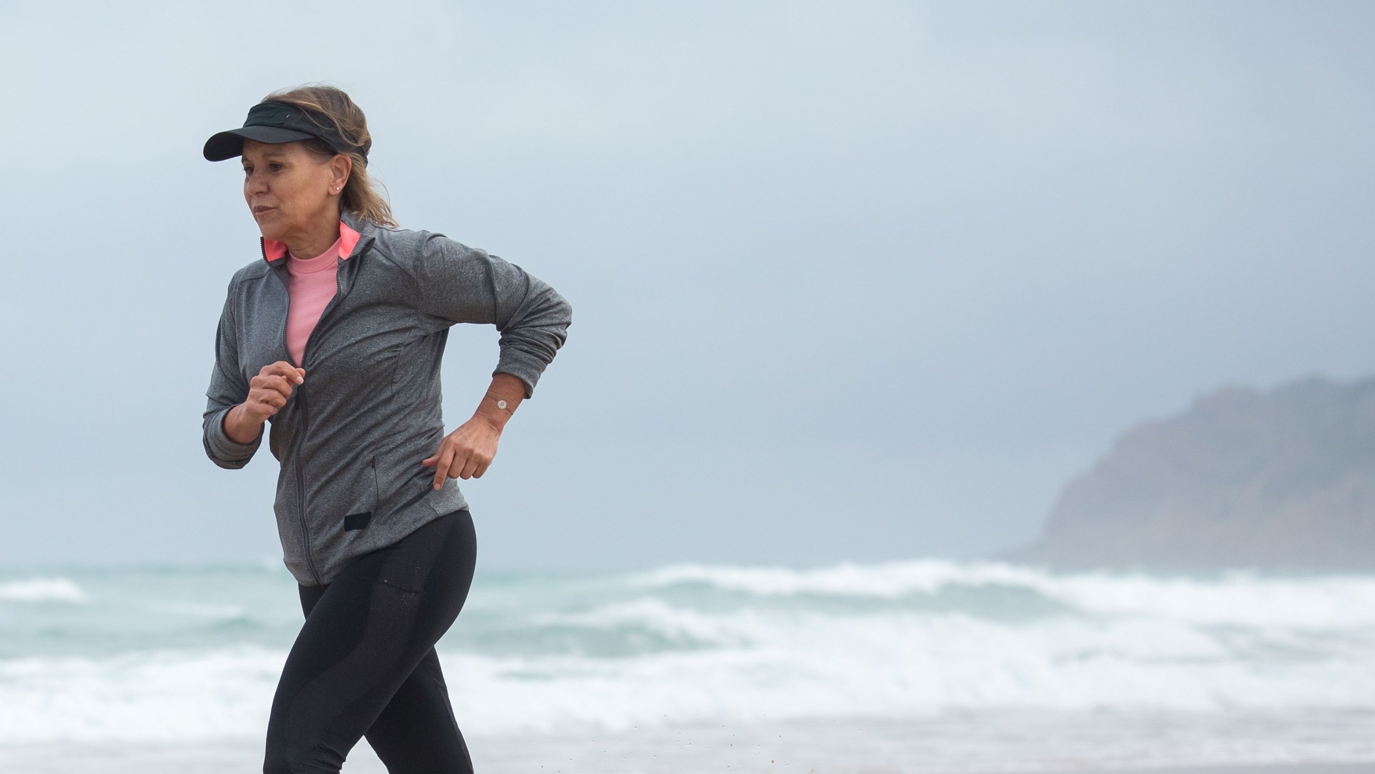 Woman jogging along the shore